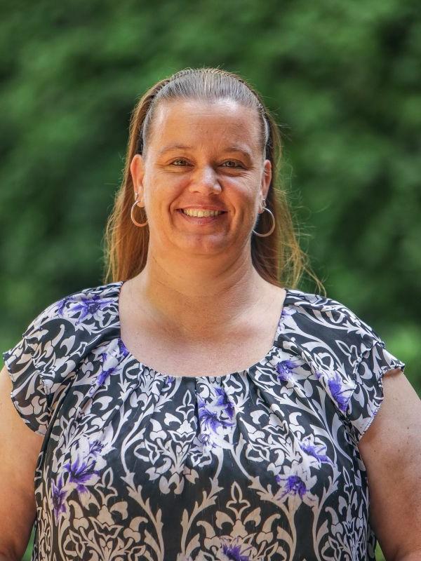 Woman smiles for a headshot 