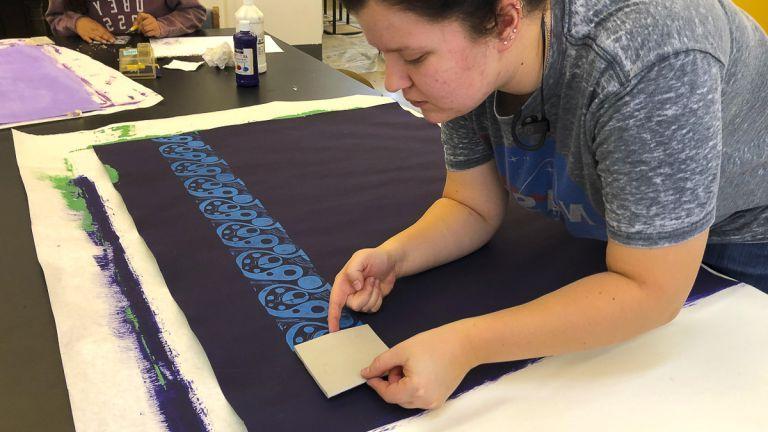 Student creating block prints