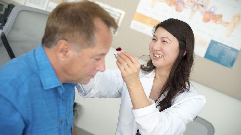 student assisting patient in clinic