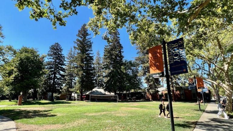 Photo shows students walking across the Quad at the Sacramento campus. 