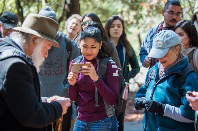 student taking picture of tour guide