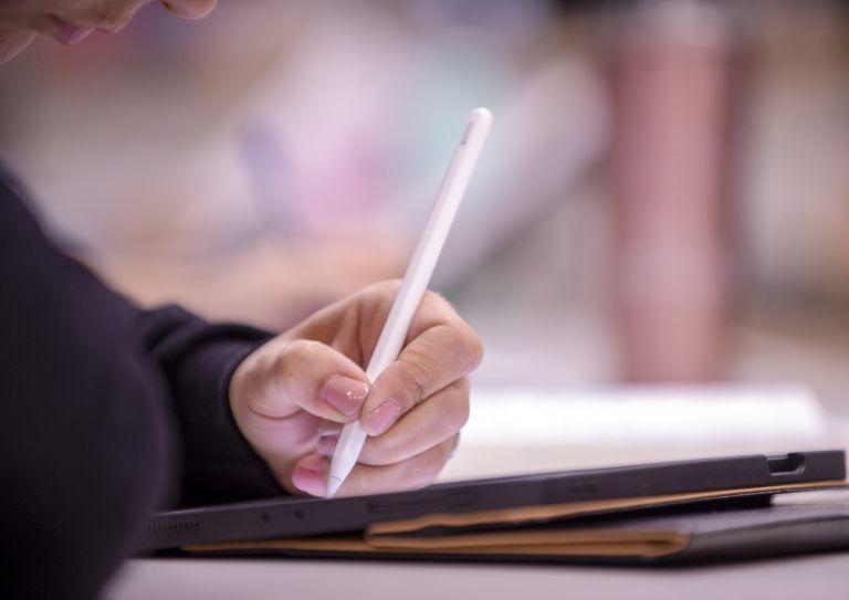 student using tablet in classroom