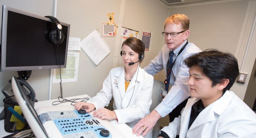 audiology professor and students in lab