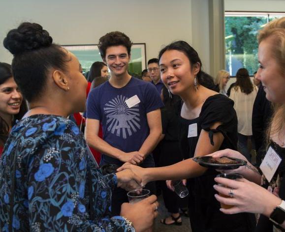 students shaking hands at event